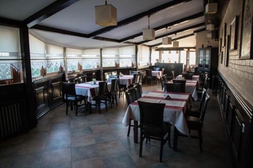 a restaurant with tables and chairs in a room at Hotel Ioana in Constanţa