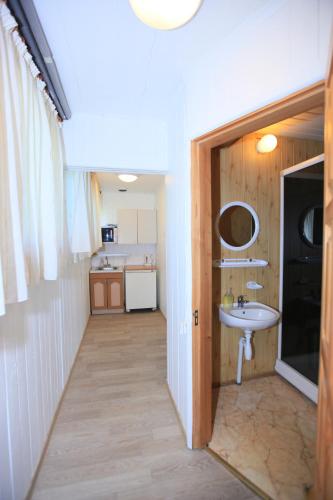 a hallway leading to a bathroom with a sink at Vila Inga in Nida