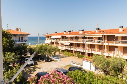 a view of a hotel with a parking lot and the ocean at Alexger Gerakini Beach house view in Gerakini