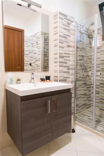 a bathroom with a sink and a shower at I Due Pini in Sogliano Cavour