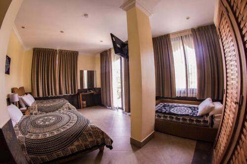 a hotel room with two beds and a large window at Dharma Beach in Montañita