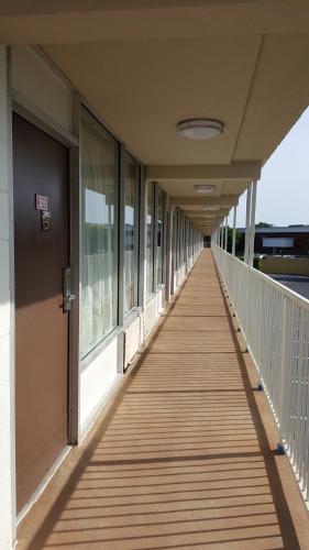 a corridor of a building with a wooden walkway at Regency Inn Richmond in Richmond