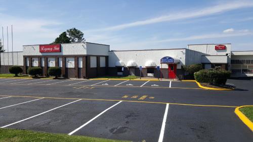 an empty parking lot in front of a store at Regency Inn Richmond in Richmond