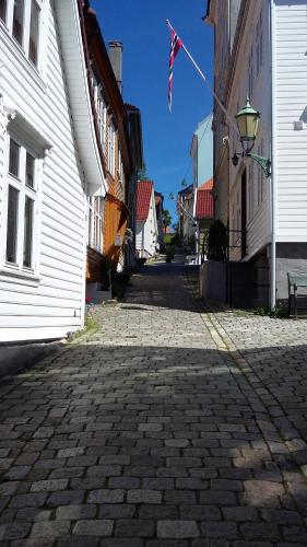 a cobblestone street with a flag on a building at The White House in Bergen