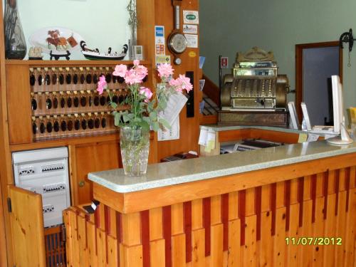 a vase of flowers on a counter in a kitchen at Hotel Prati in Castrocaro Terme