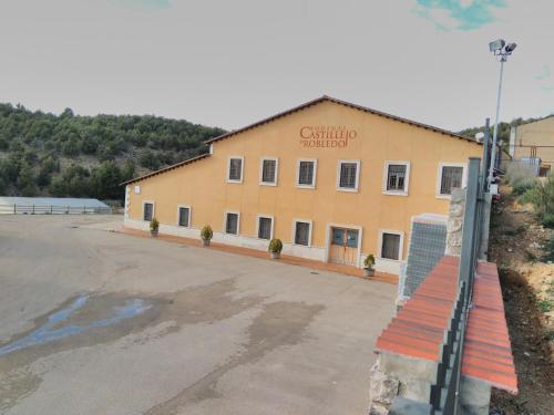 a building with a sign on the side of it at La Sabina in Castillejo de Robledo