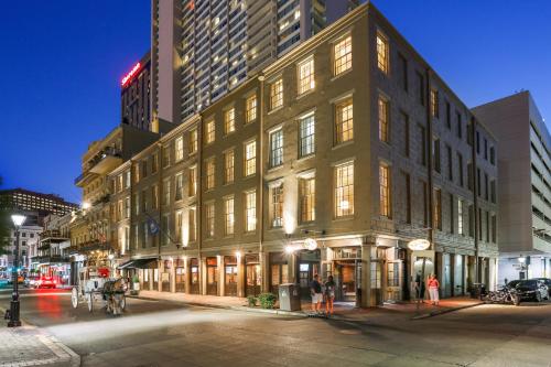 a large building on a city street at night at La Galerie French Quarter Hotel in New Orleans