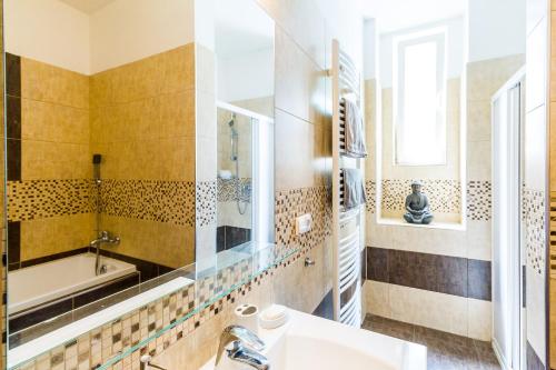 a bathroom with a sink and a bath tub at Top Wenceslas Square Apartment in Prague