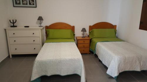 a bedroom with two beds and a dresser at El Fraile in Tejeda