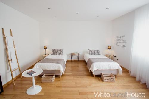 Un pat sau paturi într-o cameră la White Guest House