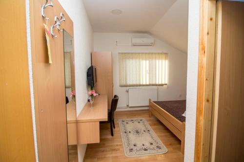 a small room with a desk and a bed at Hotel Piramida Sunca in Visoko