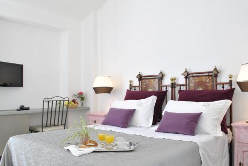 a bed with a tray of food on it at Masseria Panareo in Otranto