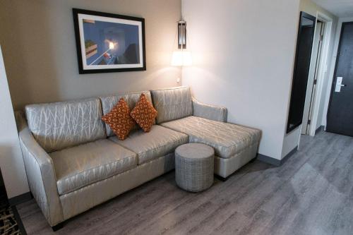 a living room with a couch and a table at Wingate by Wyndham Dallas Love Field in Dallas