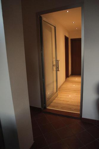 an open door to a hallway with a wooden floor at B&B La Bouganville in Alghero