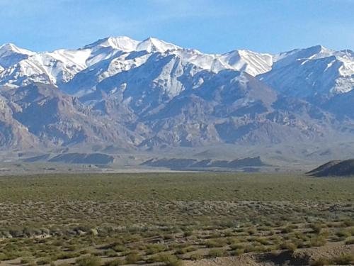 a mountain range with snow capped mountains in the distance at Balcon de Antares in Uspallata