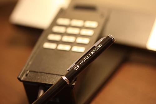 a black pen sitting on top of a cell phone at Hotel Gracery Sapporo in Sapporo