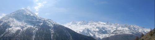 a large snow covered mountain with a blue sky at Haus Alpenperle in Saas-Almagell