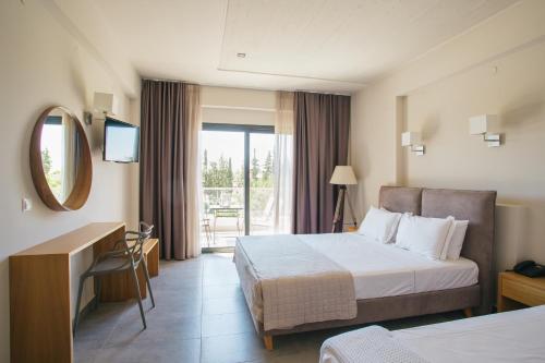 a hotel room with a bed and a mirror at Olea Mare in Kalives Poligirou