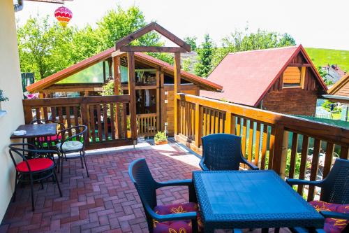 a deck with chairs and tables and a cabin at Domceky Holiday in Liptovský Trnovec
