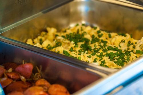 a tray of food with greens on top at Kaja Medical & Spa in Świeradów-Zdrój