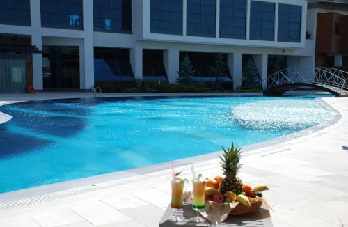 a bowl of fruit sitting next to a swimming pool at Radisson Blu Hotel & Spa, Istanbul Tuzla in Istanbul
