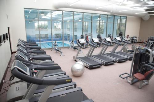 a gym with rows of tread machines and a pool at Salthill Hotel in Galway
