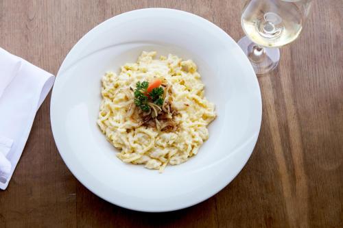 a white bowl of pasta with a carrot in it at Gasthaus Zum Kreuz in Sankt Märgen
