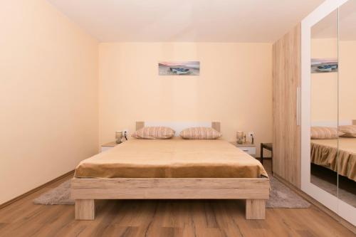a bedroom with a bed and two mirrors at Old SALONA in Solin