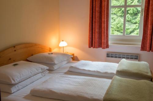 Säng eller sängar i ett rum på Hotel Restaurant Winterbach