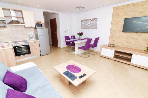 a living room with a couch and a table at Luxury Villa Star Lights Trogir - heated pool, hot tub, gym, billiard in Trogir