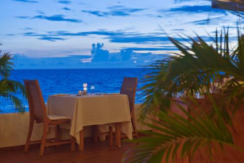 a table on the beach with the ocean in the background at Safari Island in Mushimasgali