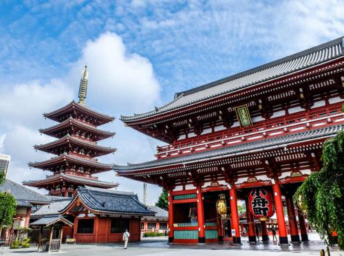 a large building with a pagoda in a city at Rimon Apartment in Tokyo