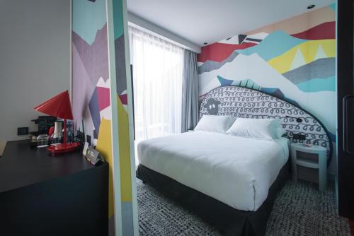 a bedroom with a bed and a dresser at ibis Styles Tbilisi Center in Tbilisi City