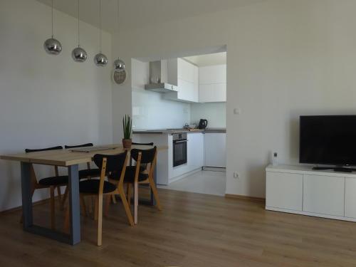 a kitchen and dining room with a table and chairs at Apartment Duce in Omiš