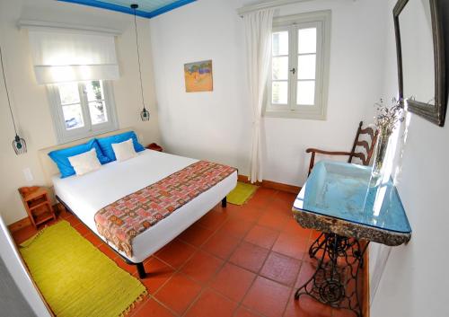 a bedroom with a bed and a table in it at Domus Nostos in Apolpaina
