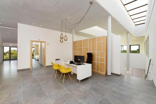 a dining room with a table and yellow chairs at Mercedes Country House in Faro