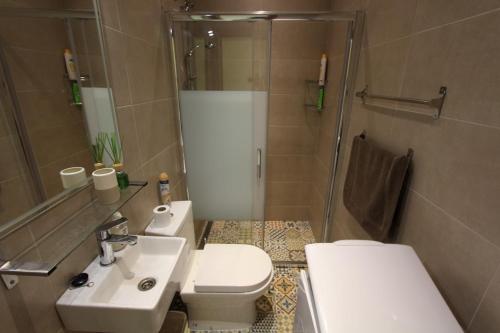 a bathroom with a toilet and a sink and a shower at Bungalow 3931 in Torrevieja