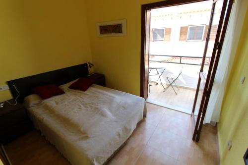 a bedroom with a bed and a door to a balcony at Bungalow 3931 in Torrevieja