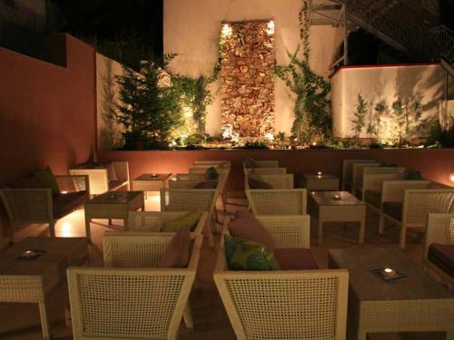 a restaurant with white chairs and tables and lights at Studios Karavos in Aliveri