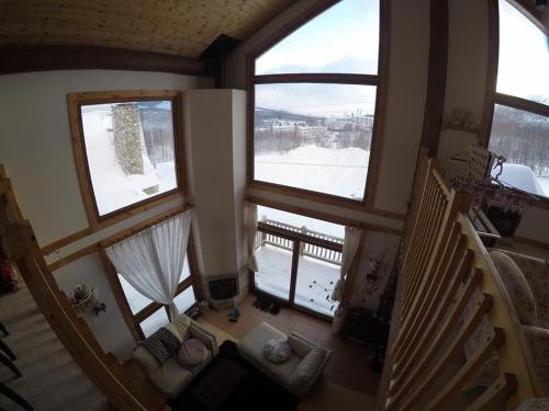 an overhead view of a living room with two large windows at Ohisama House in Rusutsu