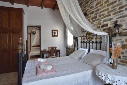 a bedroom with a bed and a table with towels on it at Kolymbithres Seaside Villa in Kolympithres