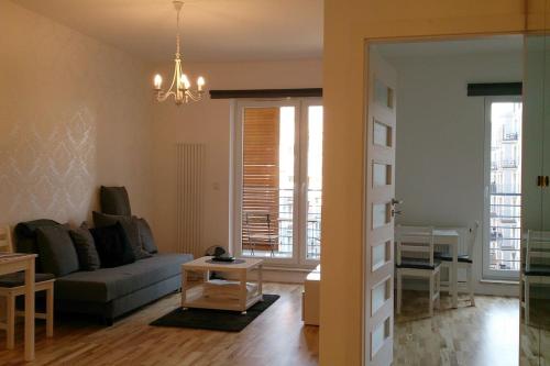 a living room with a couch and a table at 1 Bedroom Francuska Park Apartment in Katowice
