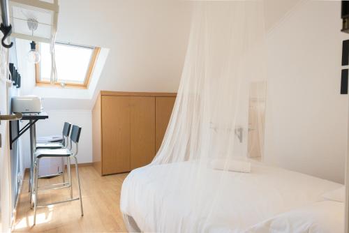 a bedroom with a bed with a mosquito net at Bica Mini Hostel in Lisbon