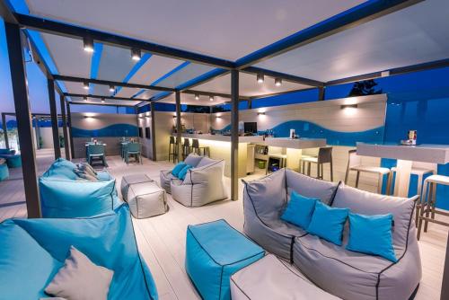 a patio with blue and white furniture and a bar at Maritina Hotel in Kos Town