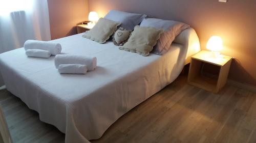 a bedroom with a bed with white sheets and pillows at La bastide de Lily in Séguret