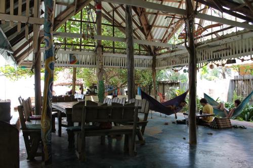 a group of people sitting in hammocks in a restaurant at Sanctuary Lanta in Ko Lanta