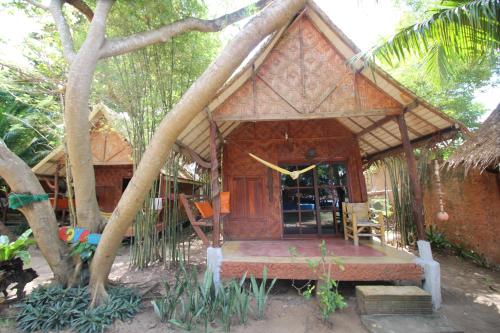a small house with a porch in a forest at Sanctuary Lanta in Ko Lanta