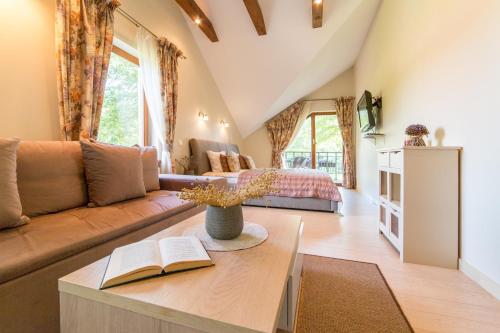 a living room with a couch and a bed at Rasos Vila in Palanga