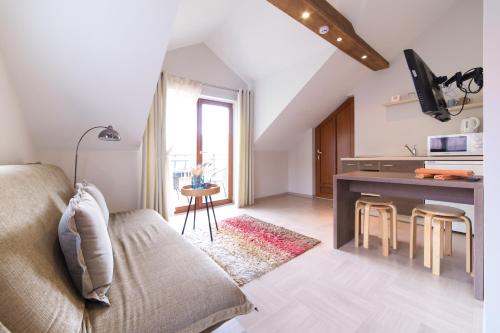a living room with a couch and a table at Rasos Vila in Palanga