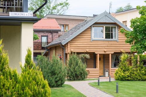 a wooden house with a pathway in front of it at Rasos Vila in Palanga